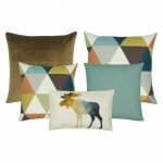 A plain brown cushion cover, a pair of cushion cover with triangle designs, a blue cushion cover and one rectangular cushion cover