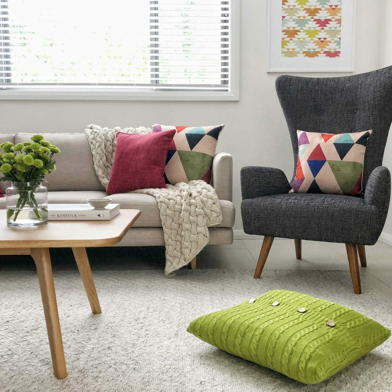 A grey and cream sofa decorated in patterned cushions