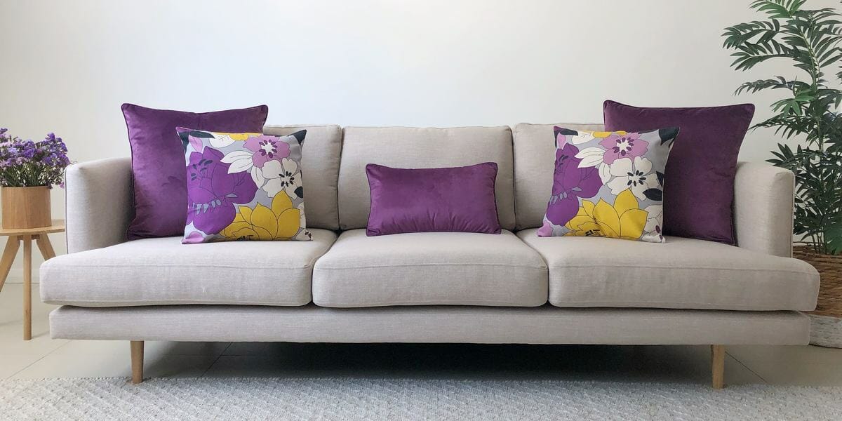 Grey sofa with velvet purple and floral cotton linen cushions