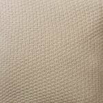 Close up photo of beige cushion cover made of wool knit material