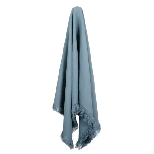 A calming blue-coloured linen throw hanging on a hook.