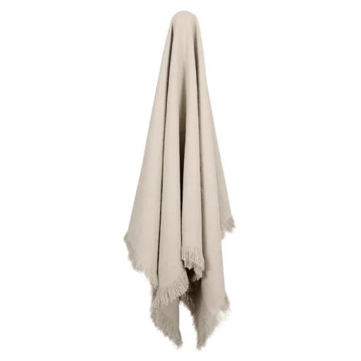 A natural linen throw drapes from a hook.