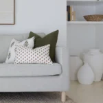 The grey sofa's corner is adorned with cushions from the Ava sofa cushions set of 5.