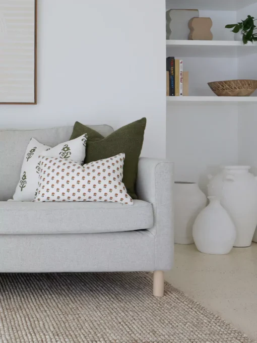 The grey sofa's corner is adorned with cushions from the Ava sofa cushions set of 5.