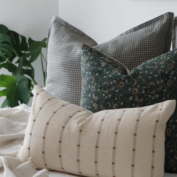 A bedroom scene with a set of luxury cushions shown.