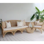 Outdoor seating with a set of 5 beige outdoor sofa cushions on it.