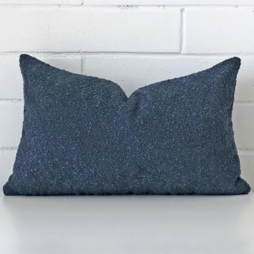 Dark blue boucle blue cushion with texture on white wall