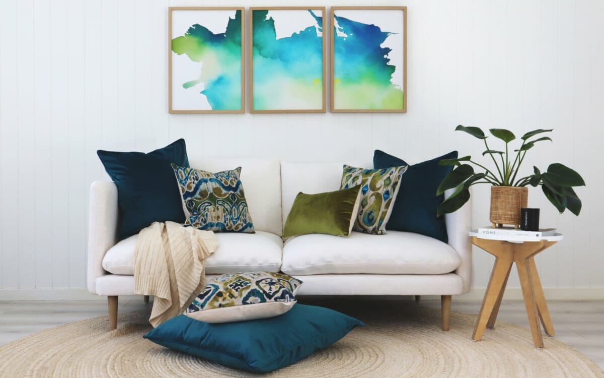 Our Farsi range of ikat cushions styled on a white sofa with abstract art on the wall