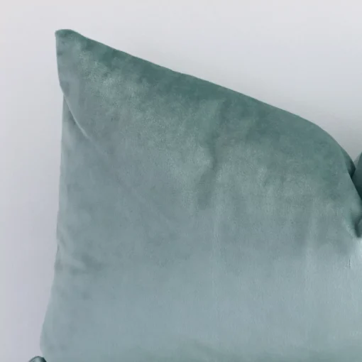 Focused view of velvet rectangular cushion cover. The shot shows details of its velvet material and mint colour.