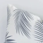 Macro image of an outdoor rectangle cushion cover. The shot shows the grey hue and palm style more thoroughly.