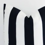 The corner of this outdoor large cushion cover is shown close up. The stripe design and black and white colour are shown in greater detail.