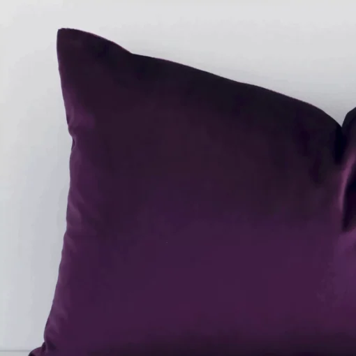 Zoomed in visual of velvet rectangular cushion cover in plum purple. Its classy solid colour design is more visible.