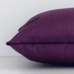 Rectangular velvet cushion cover positioned flat to show seams. The plum purple hue and solid colour design are shown between front and rear fabric panels.