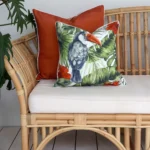 Terracotta outdoor cushions on a rattan sofa.