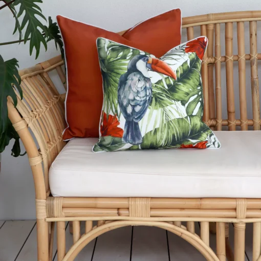 Terracotta outdoor cushions on a rattan sofa.